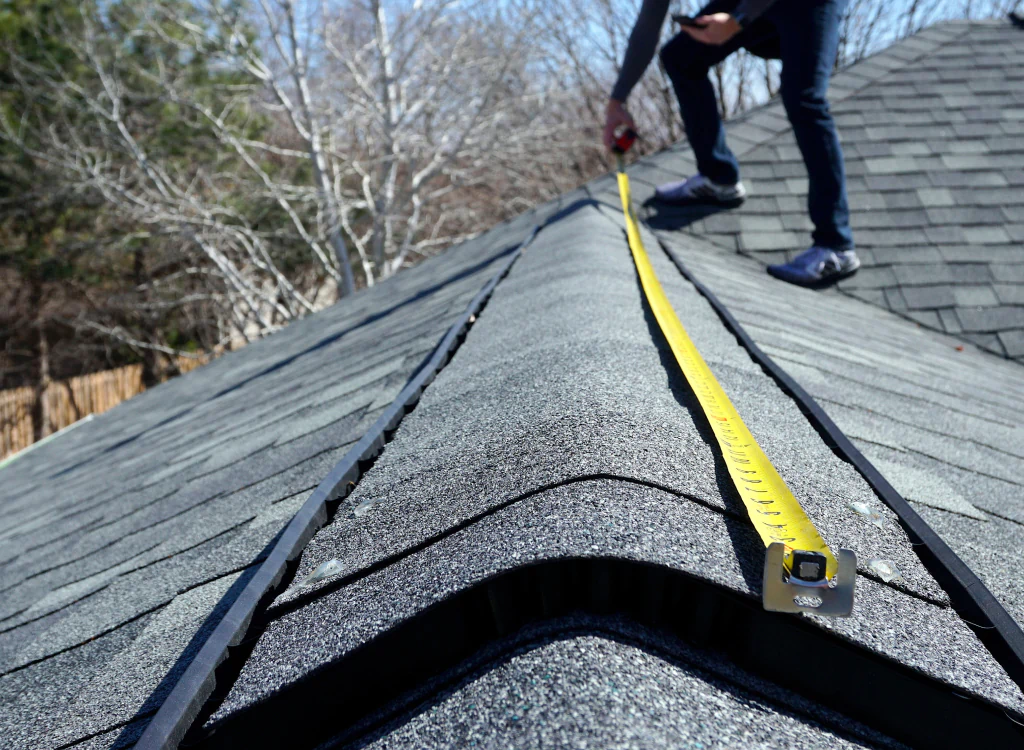 a man inspecting a house roofing